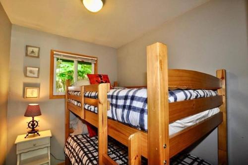 a bedroom with two bunk beds in a room at Muskoka Manor in Dwight