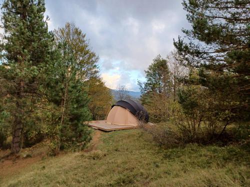 une tente installée au sommet d'une colline dans les bois dans l'établissement SIMBIOSIS. Agri Cultur'Art Camp, à Pontinvrea