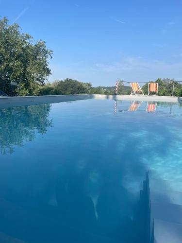 a large pool of water with a bridge in the background at Corte Attilea in Valeggio sul Mincio