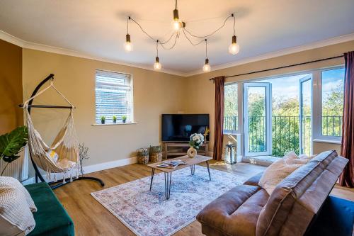 a living room with a couch and a table at Windermere Lake View Retreat, Pet Friendly, Free Parking, Golf nearby in Bowness-on-Windermere