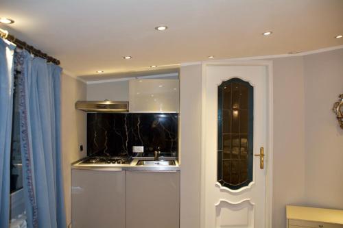 a kitchen with a sink and a stove at Twins Apartments in Sanremo