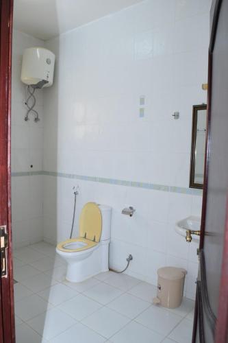 a bathroom with a toilet and a sink at Red-37 - Bn Breek Villa in Salalah
