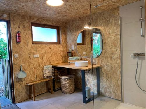 a bathroom with a sink and a shower at La Ville Es Renais - ferme et maison d'hôtes insolite in Erquy