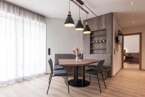 a dining room with a table and chairs at Bergmadl Apartments in Neustift im Stubaital