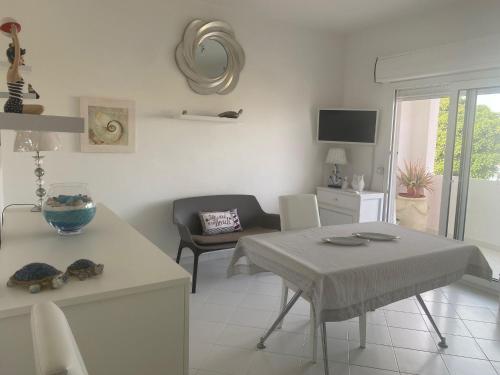 a kitchen and living room with a table and chairs at La Salina in Lampedusa