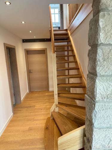 a staircase in a house with a stone wall at Gutshof Andres in Kirchlauter