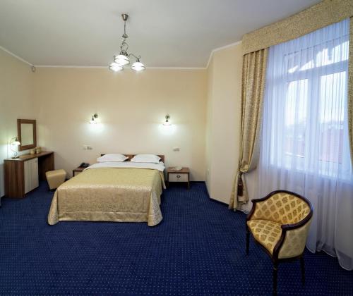 a hotel room with a bed and a window at Svityaz Resort in Truskavets