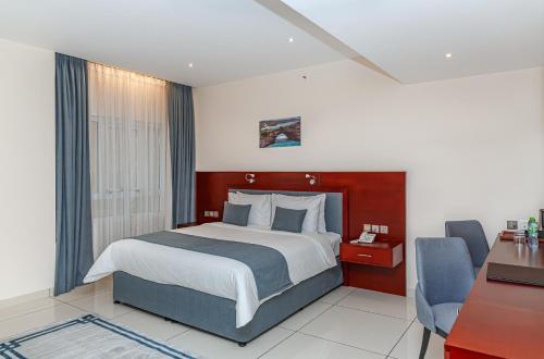 Voodi või voodid majutusasutuse Salalah International Hotel toas