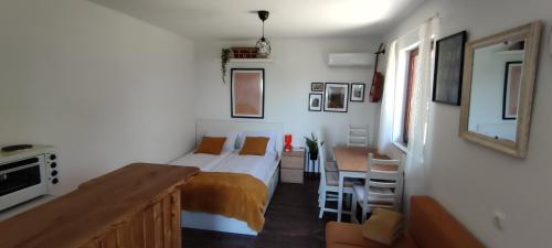 ein Schlafzimmer mit einem Bett und einem Schreibtisch sowie eine Küche in der Unterkunft House Thara Studio Apartments in Štrigova