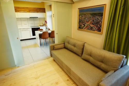 a living room with a couch and a kitchen at Magio Apartments in Turda