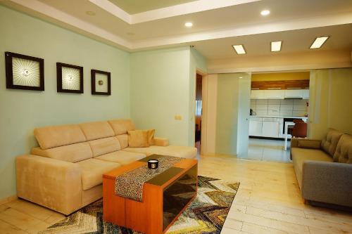 a living room with a couch and a coffee table at Magio Apartments in Turda