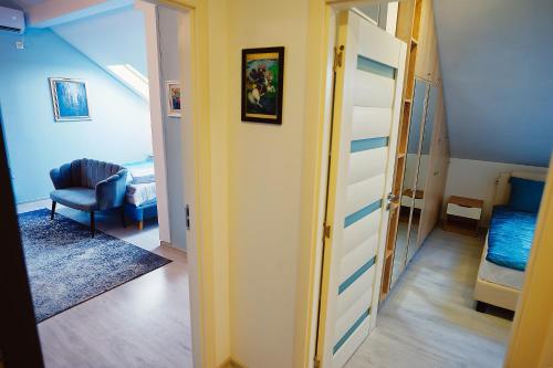 a hallway with a door open to a living room at Magio Apartments in Turda