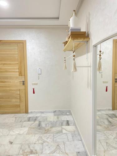 a room with white walls and a stone floor and a door at Studio SvEt 19 in Mohammedia