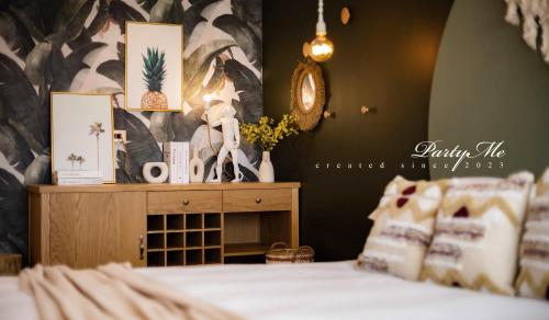 a bedroom with a bed and a dresser with at Party Me 派對蜜民宿 in Dongshan
