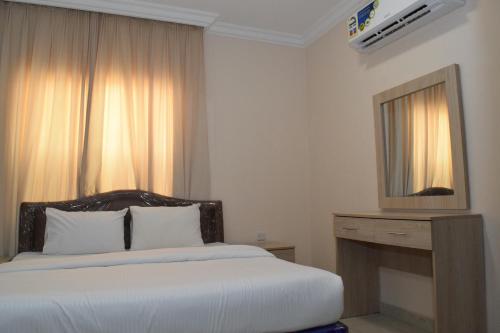 a hotel room with a bed and a television at RED Royal Inn in Salalah