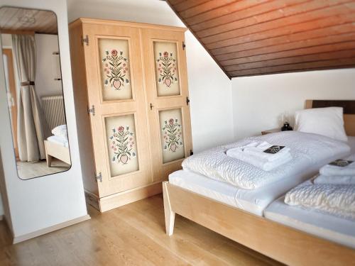 a bedroom with a bed and a mirror in it at Gasthof Auwirt in Sankt Michael im Lungau
