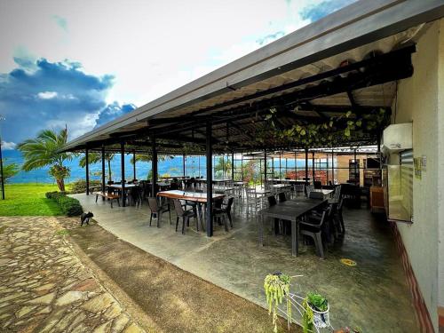 a restaurant with tables and chairs and a dog standing outside at Altamira Biohotel in Socorro