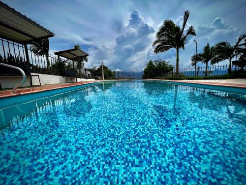 a large blue swimming pool with blue water at Altamira Biohotel in Socorro