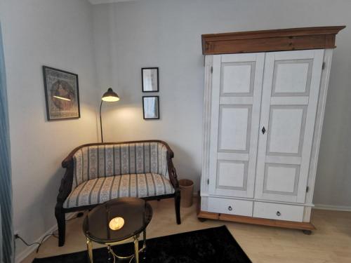 a living room with a chair and a door at HR Haus unter den Linden in Coesfeld