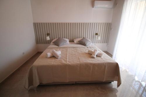 a bedroom with a bed with two towels on it at Villa Hortus in Neum
