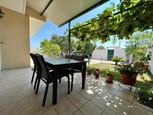 a black table and chairs on a patio at Villa Maria - Koropi in Koropi