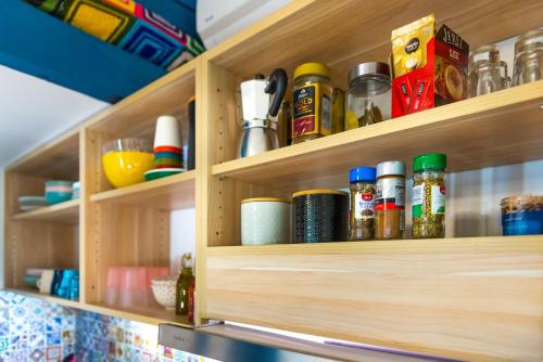 a wooden pantry shelf with spices and condiments at Boho House 4 camp Terme Catez with promotional tickets prices in Čatež ob Savi