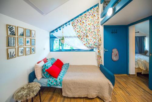 a bedroom with a bed and a window at Boho House 4 camp Terme Catez with promotional tickets prices in Čatež ob Savi