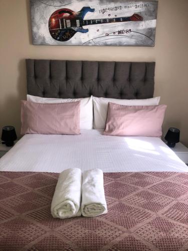 a bedroom with a bed with two towels on it at Menlyn Bizcation Accommodation in Pretoria