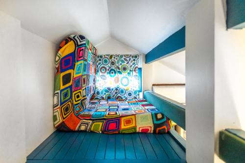 a room with a colorful chair on a staircase at Boho House 4 camp Terme Catez with promotional tickets prices in Čatež ob Savi