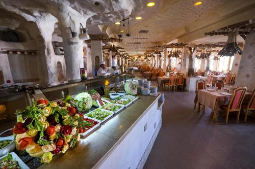 a restaurant with a buffet line with vegetables on it at Les Quatre Saisons Ex Baya Beach in Djerba