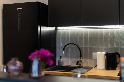 a kitchen counter top with a sink and a counter top at FLATMORE Apartament Akacjowa 17m1A in Zielona Góra