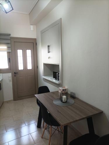 a dining room with a wooden table and chairs at Zeta ' s house in Nafpaktos