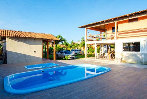 a swimming pool on the deck of a house at Pousada das Estrelas in Joanes