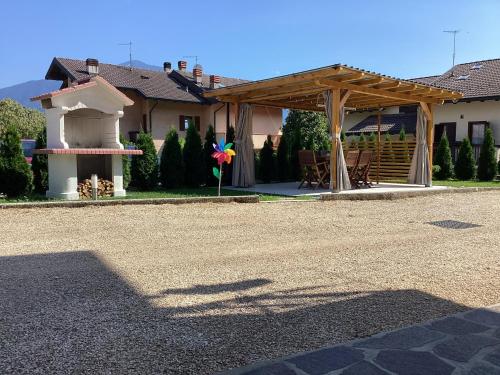 a house with a wooden pergola and a patio at LA STELLA DELLE DOLOMITI in Pedavena