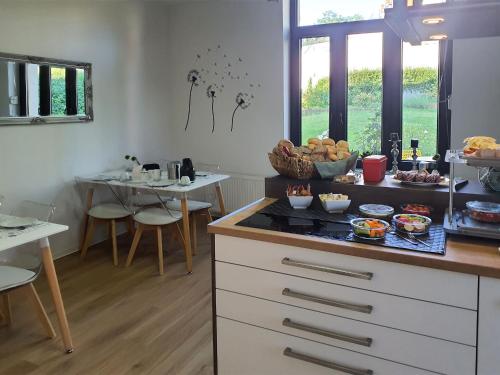 a kitchen with a counter with some food on it at Designpension Idyll Nr2 Hotel Garni in Wernigerode