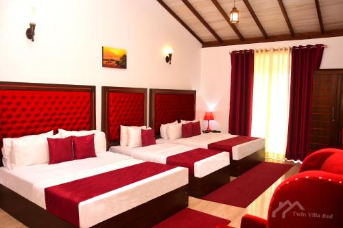 two beds in a room with red and white at Twin Villa Red in Nuwara Eliya