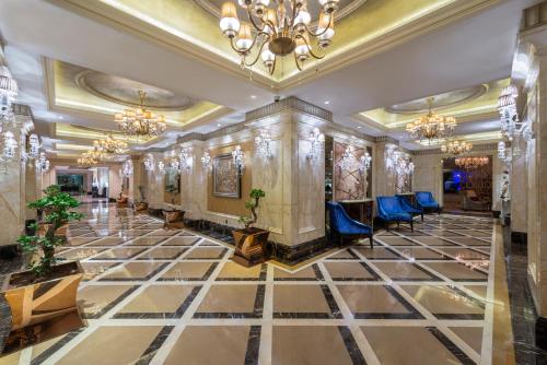 a lobby of a hotel with a chandelier at Narcissus Riyadh Hotel & Spa in Riyadh