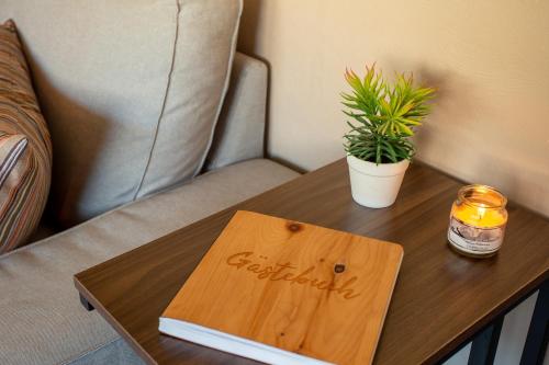 a wooden table with a book on top of it at Ferienwohnung Airone Nero in Gerolstein