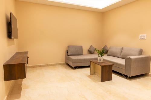 a living room with a couch and a table at LK GRAND HOME in Tirupati