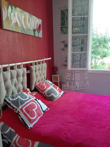 - une chambre avec un lit doté de draps et d'oreillers roses dans l'établissement Bel appartement-terrasse Ronce-les-Bains, à La Tremblade