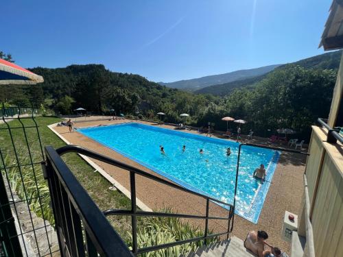 a view of a swimming pool with people in it at le logis du désert in Saint-Nazaire-le-Désert