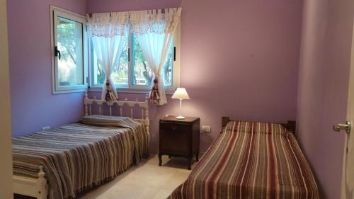 a bedroom with two beds and a window at Indigo in Carpintería