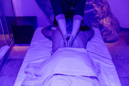 a person is making a bed in a room at Villa Marina Capri in Capri