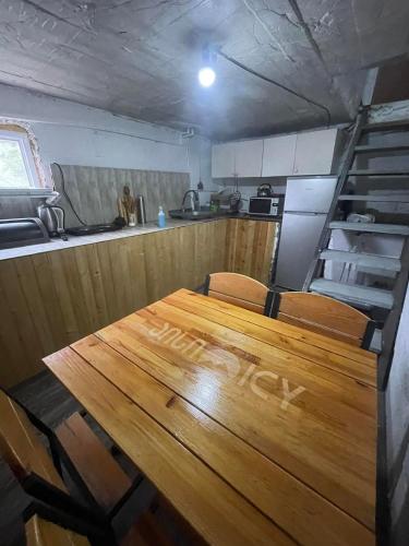 a table with chairs and a kitchen in a room at Cottage - Location Lanchvali in Mestia
