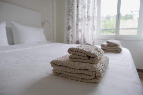 a pile of towels sitting on top of a bed at Supernova in Savona