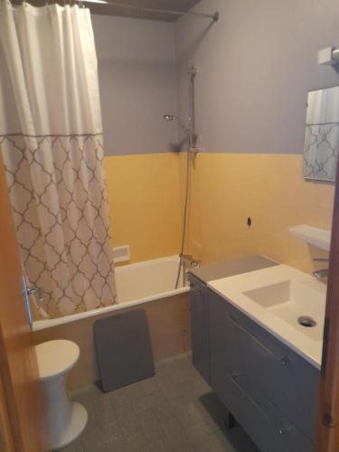 a bathroom with a sink and a toilet and a tub at Les Granges in La Clusaz