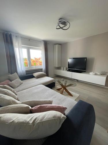 a living room with two beds and a flat screen tv at Albblick in Albstadt