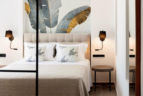 a bedroom with a large bed with white sheets and pillows at Golden Bay luxury villas and suites in Chrissi Akti