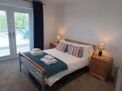 a bedroom with a bed with towels on it at Admiral's View - Apartment 1 in Scarborough