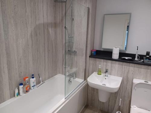 a bathroom with a shower and a sink and a bath tub at Admiral's View - Apartment 1 in Scarborough